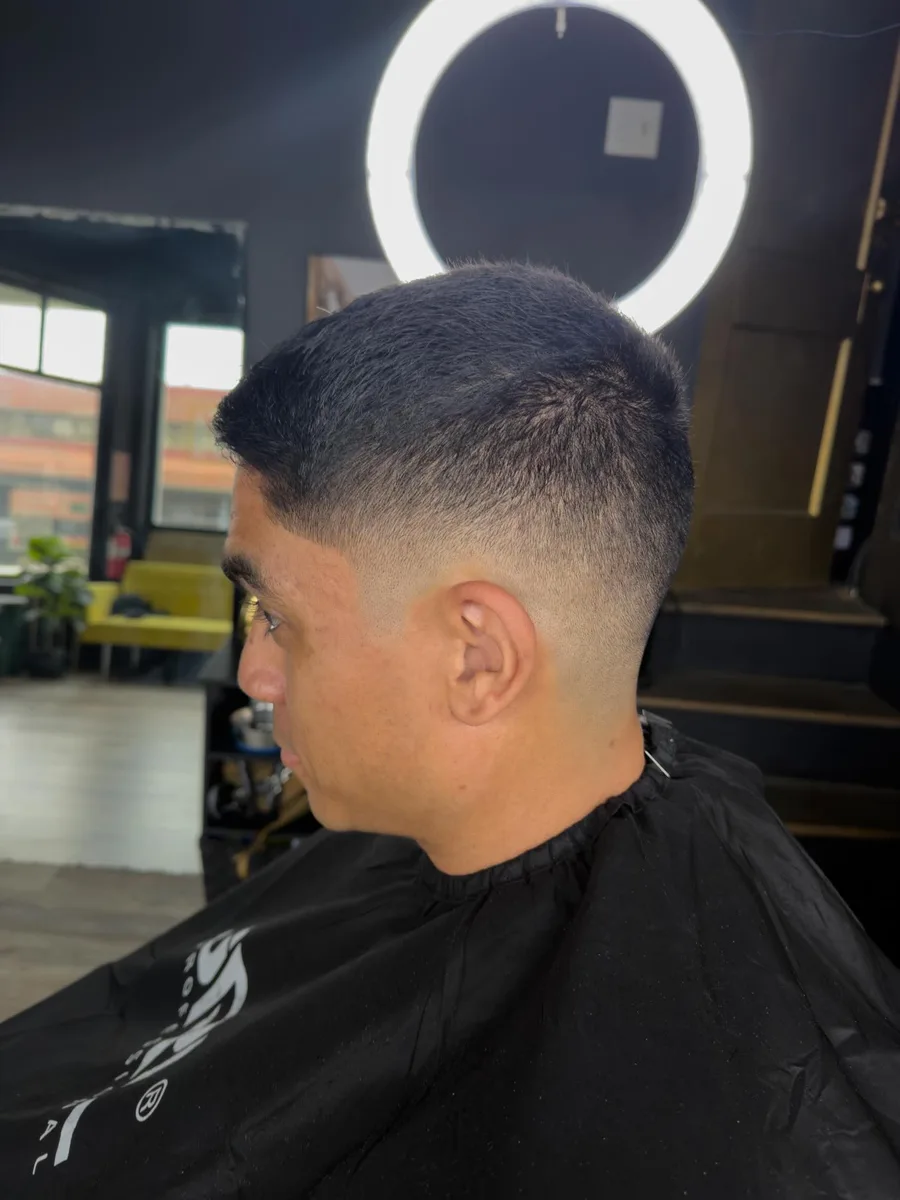 Low taper fade under the ring light, side profile