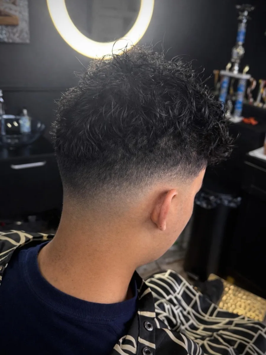 Textured curly top with a clean faded back